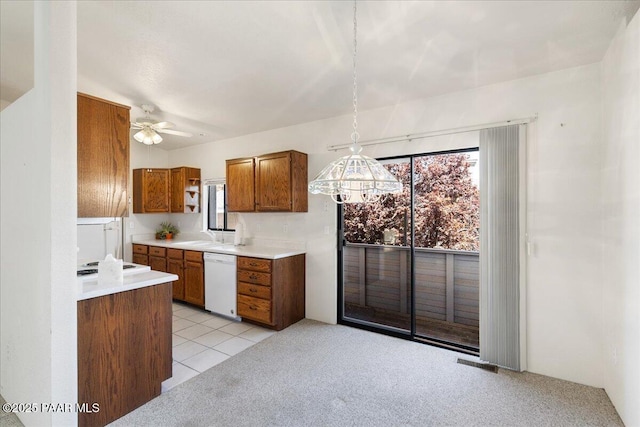 kitchen with white appliances, plenty of natural light, light countertops, and brown cabinets
