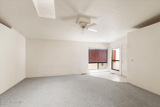unfurnished room with a ceiling fan and light carpet