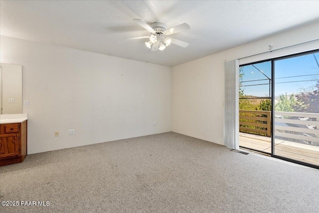 unfurnished room featuring visible vents, a ceiling fan, and light colored carpet