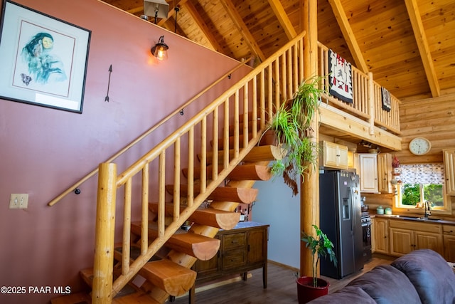 stairway with wood ceiling, beam ceiling, and rustic walls