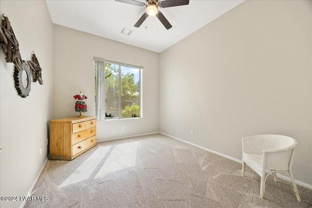 sitting room featuring light carpet, ceiling fan, and lofted ceiling