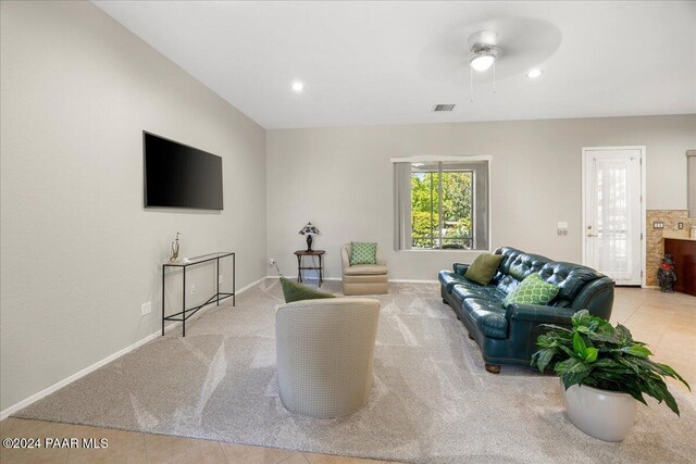 tiled living room featuring ceiling fan