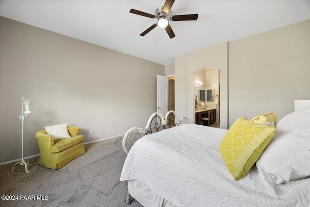 bedroom with ensuite bath, ceiling fan, and carpet