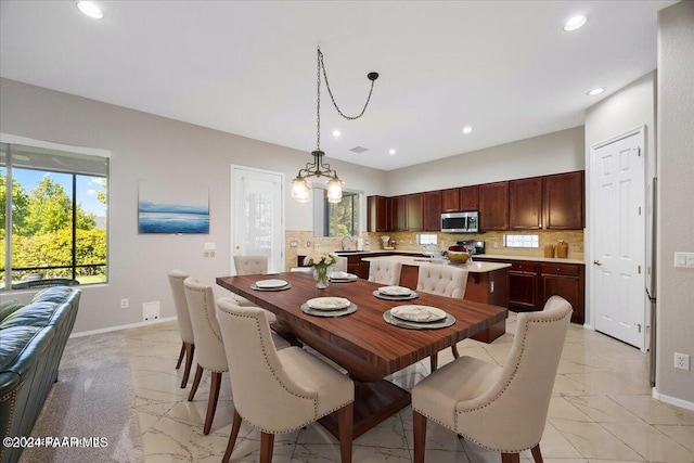 dining space with an inviting chandelier