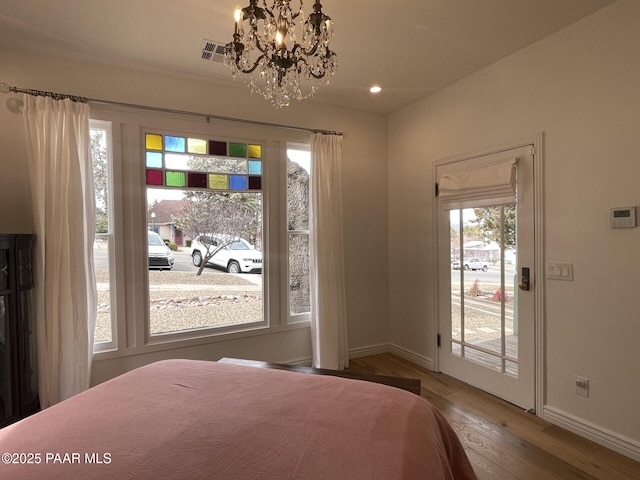 bedroom featuring wood finished floors, baseboards, an inviting chandelier, recessed lighting, and access to exterior