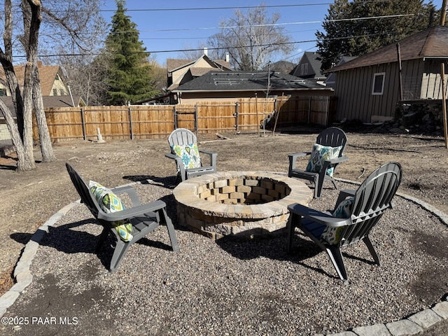 view of yard with a fenced backyard and an outdoor fire pit