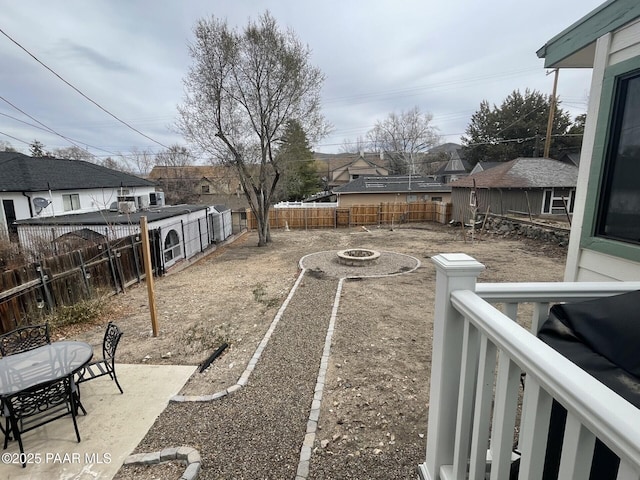 view of yard with a fenced backyard and a fire pit