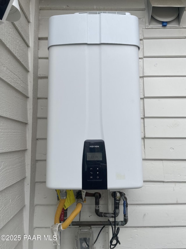 exterior details featuring tankless water heater