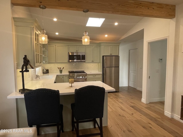 kitchen with lofted ceiling with beams, tasteful backsplash, stainless steel appliances, a peninsula, and light countertops