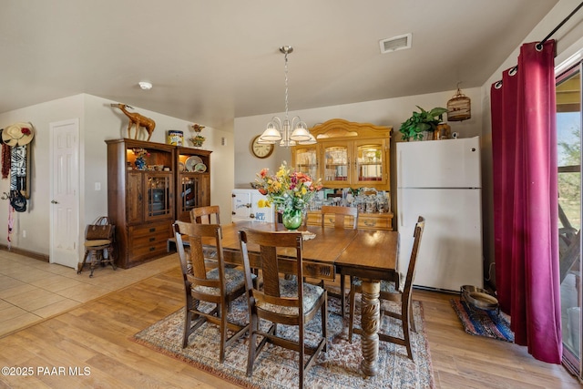 25820 N Poppy Dr, Paulden, AZ 86334 - dining area with a chandelier and light wood-style floors