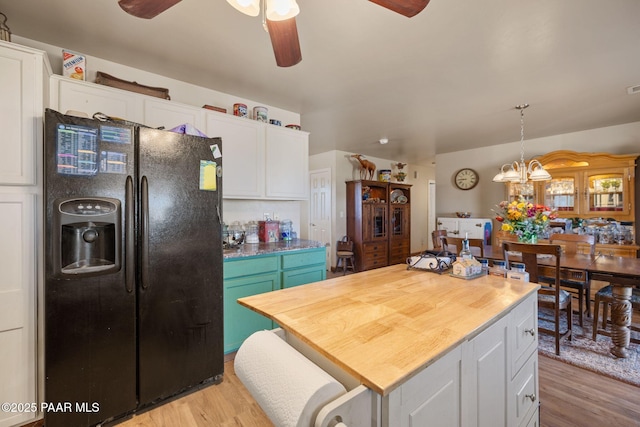 25820 N Poppy Dr, Paulden, AZ 86334 - kitchen with black fridge with ice dispenser, a ceiling fan, white cabinets, and light wood-type flooring