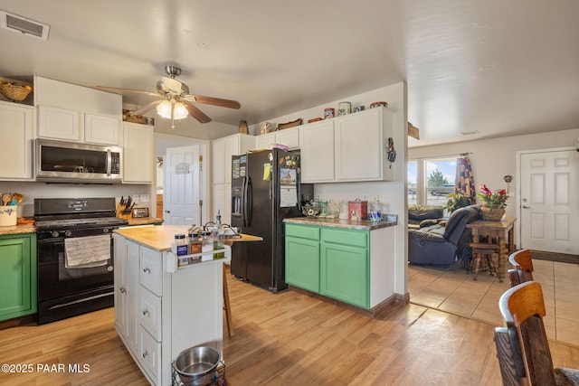 25820 N Poppy Dr, Paulden, AZ 86334 - kitchen with black appliances, a ceiling fan, green cabinets, a center island, and light wood-style flooring