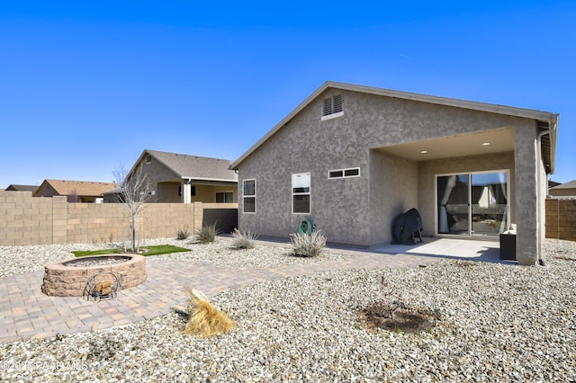 5234 N Elliot Ave, Prescott Valley, AZ 86314 - rear view of property with stucco siding, a patio area, fence, and an outdoor fire pit