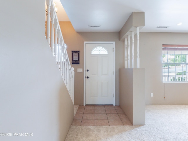 5700 N Concho Dr, Prescott Valley, AZ 86314 - tiled foyer featuring stairs, carpet, and plenty of natural light
