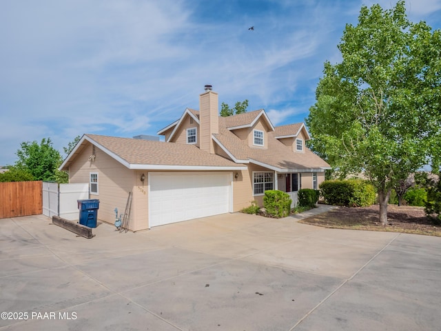 5700 N Concho Dr, Prescott Valley, AZ 86314 - traditional-style home featuring driveway, an attached garage, a chimney, and a shingled roof