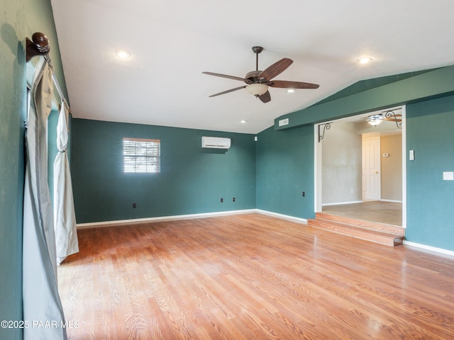 5700 N Concho Dr, Prescott Valley, AZ 86314 - empty room featuring ceiling fan, vaulted ceiling, light wood-style floors, a wall mounted AC, and baseboards
