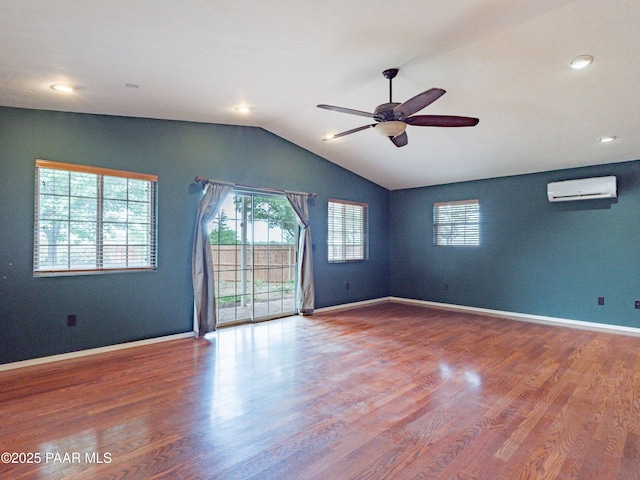 5700 N Concho Dr, Prescott Valley, AZ 86314 - empty room with a wall mounted AC, ceiling fan, wood finished floors, vaulted ceiling, and baseboards