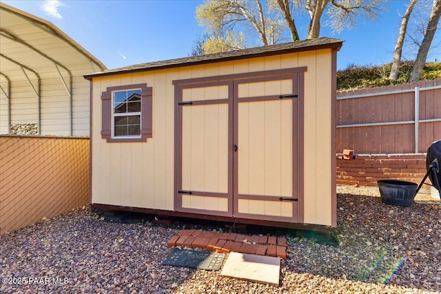 view of shed with a fenced backyard