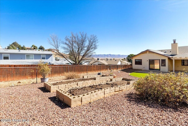 view of yard with a fenced backyard and a garden