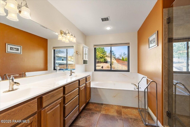 bathroom with a garden tub, double vanity, visible vents, a shower with shower door, and a sink