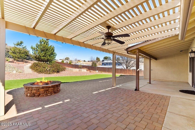 view of patio / terrace featuring fence, a fire pit, and a pergola