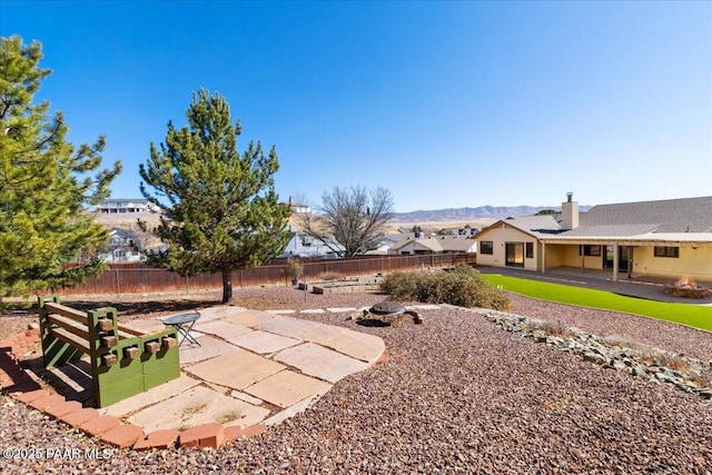 view of yard with a fire pit, a patio area, and a fenced backyard