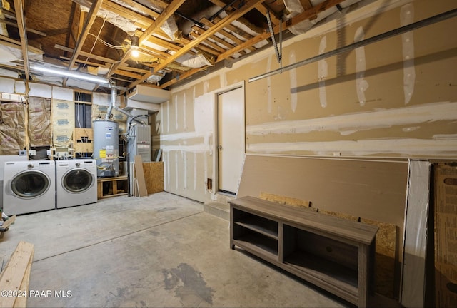 basement with washer and dryer, heating unit, and water heater