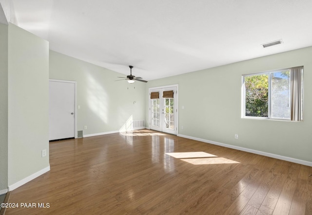 empty room featuring hardwood / wood-style floors, french doors, and ceiling fan