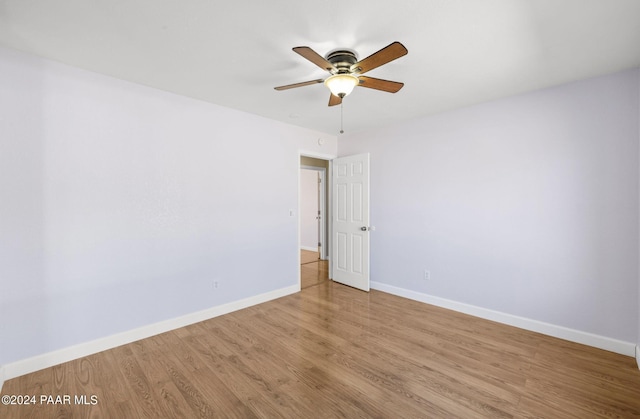 empty room with light hardwood / wood-style flooring and ceiling fan