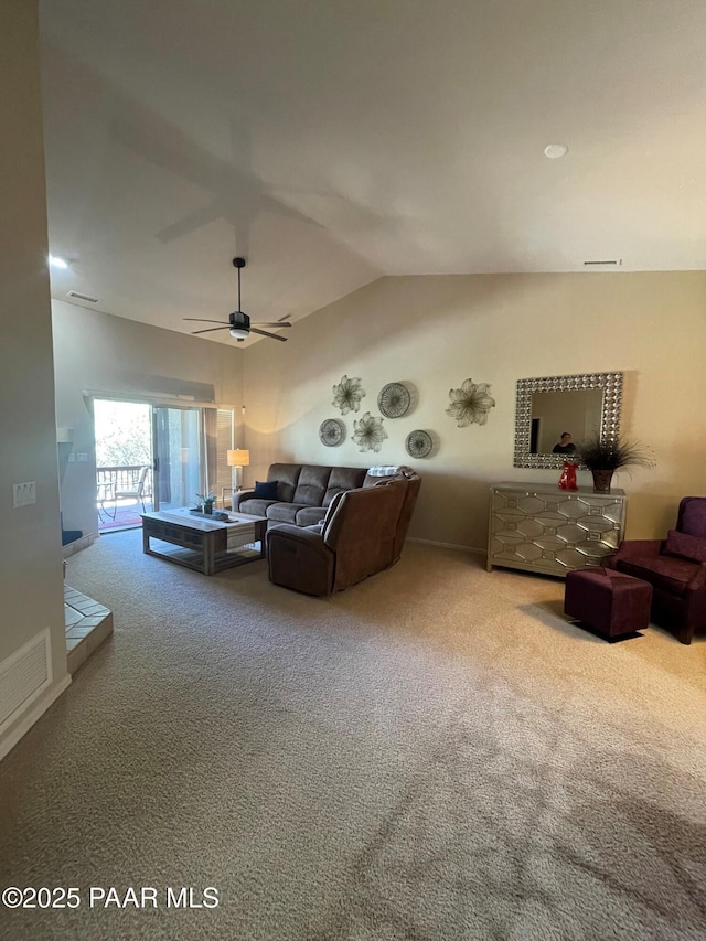 carpeted living area featuring a ceiling fan, visible vents, and lofted ceiling