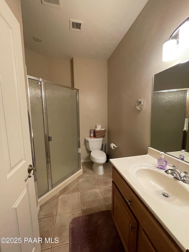 bathroom featuring a stall shower, visible vents, tile patterned floors, and vanity