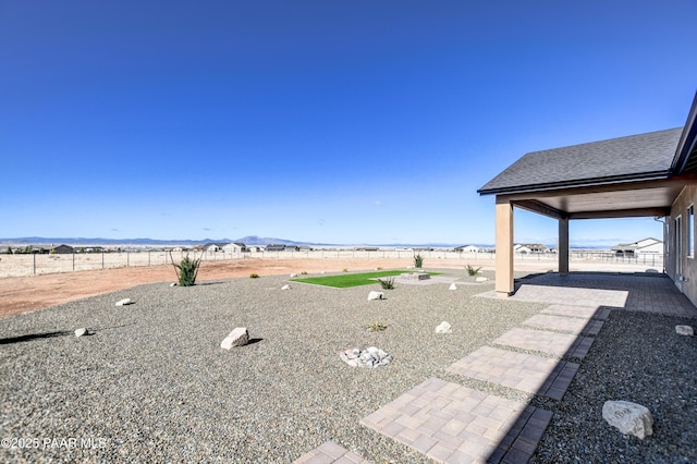 view of yard featuring a mountain view and a fenced backyard