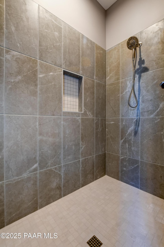 bathroom with a tile shower