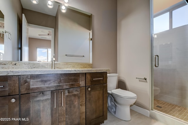 full bath featuring vanity, tile patterned floors, toilet, and a stall shower