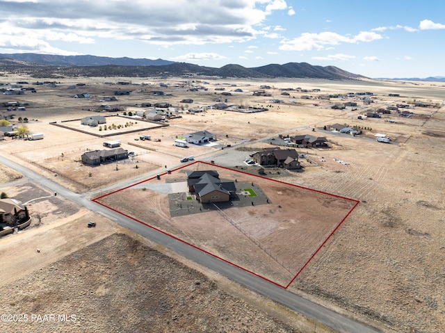 birds eye view of property with a desert view, a rural view, and a mountain view