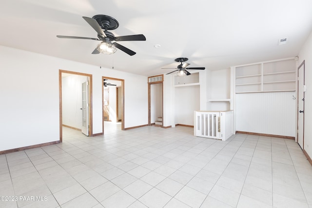 tiled spare room with built in shelves and ceiling fan