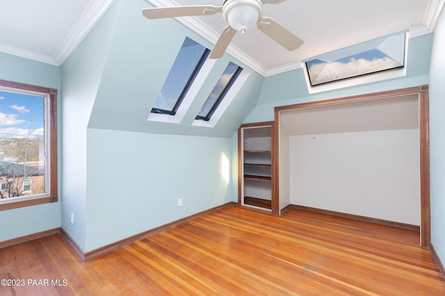 additional living space with hardwood / wood-style floors, ceiling fan, and lofted ceiling