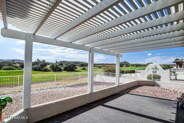 view of patio / terrace with a pergola and a rural view