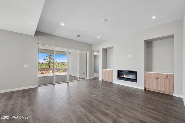 unfurnished living room with dark hardwood / wood-style flooring