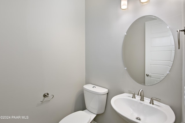 bathroom with toilet and a sink
