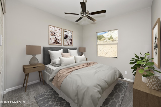 bedroom with baseboards and dark carpet