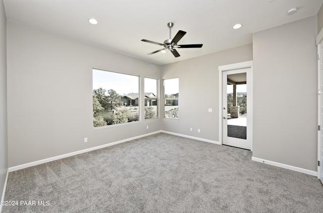 carpeted spare room featuring ceiling fan, baseboards, a healthy amount of sunlight, and recessed lighting
