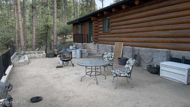 view of patio with a fire pit