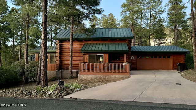 log cabin featuring a garage