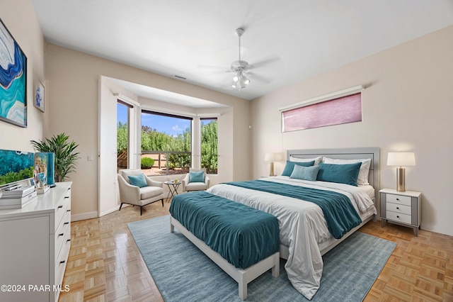 bedroom with ceiling fan and light parquet floors