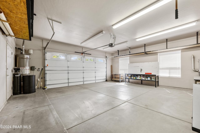 garage featuring gas water heater and a garage door opener