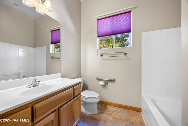 bathroom featuring plenty of natural light, toilet, and vanity