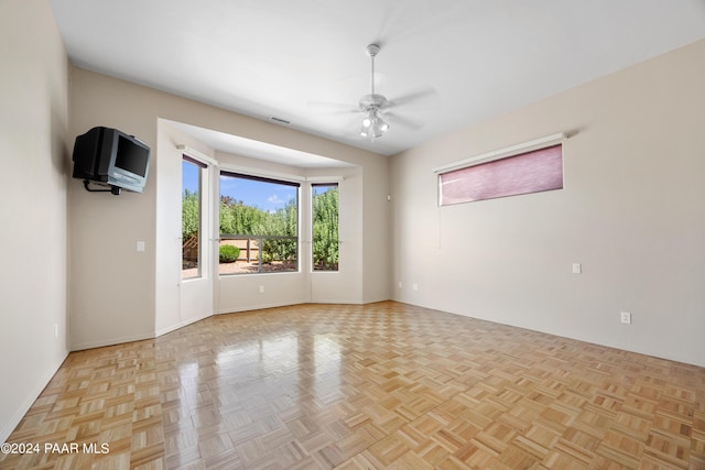 spare room featuring light parquet floors and ceiling fan