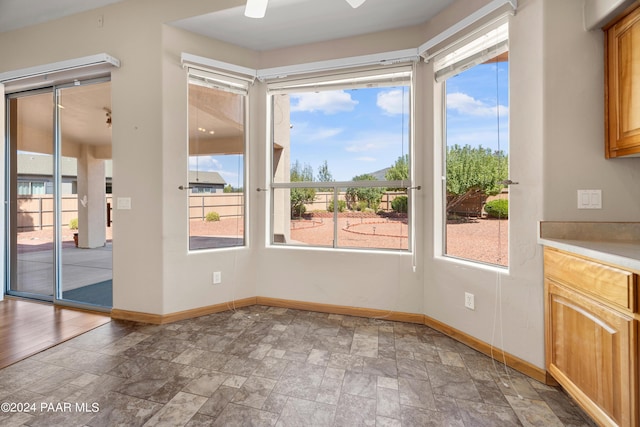 interior space featuring ceiling fan and a healthy amount of sunlight