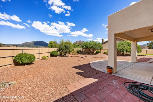 view of yard featuring a mountain view and a patio area